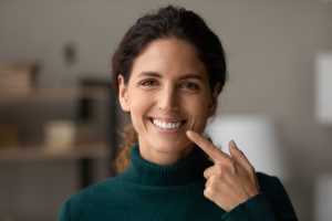 A woman pointing at her teeth