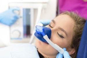 Woman receiving anesthesia through a mask